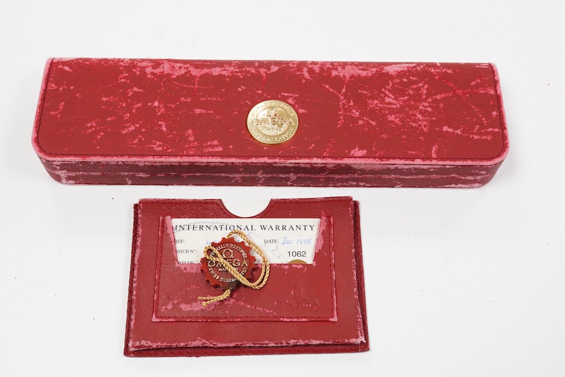 A gentleman's late 1990's 18ct gold Omega Automatic Chronometer wrist watch, with baton numerals and date aperture, case diameter 35mm, on an associated leather stray with plated buckle with Omega insignia, with box and